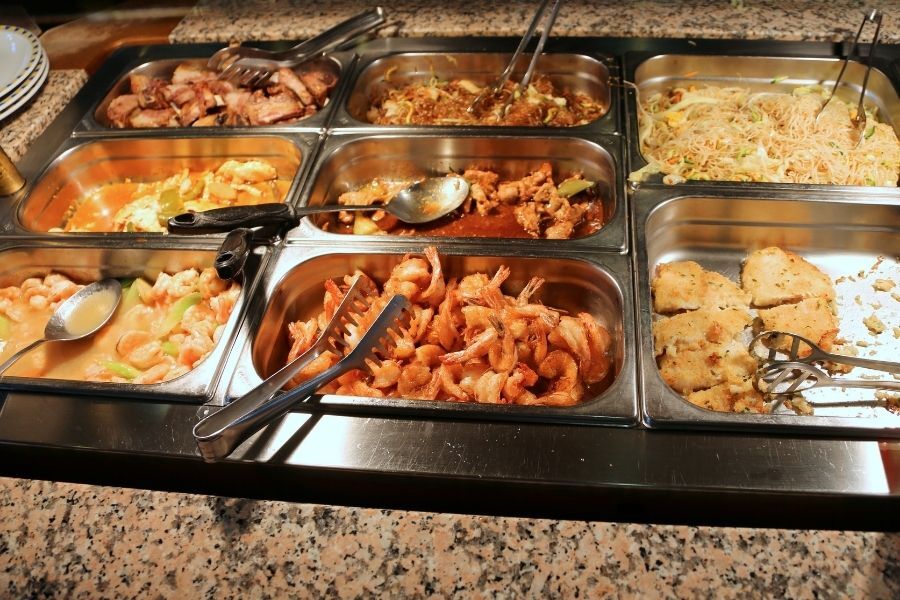 Southern style buffet spread with fried chicken and collard greens at a New York City restaurant